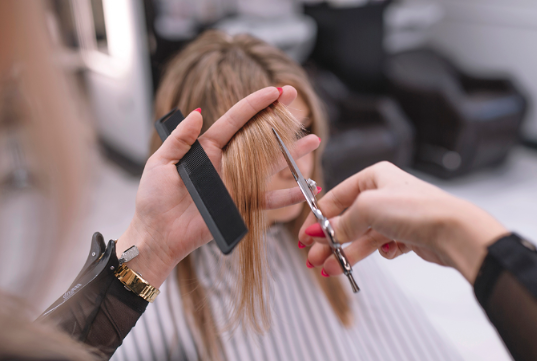 Hairdresser cutting hair
